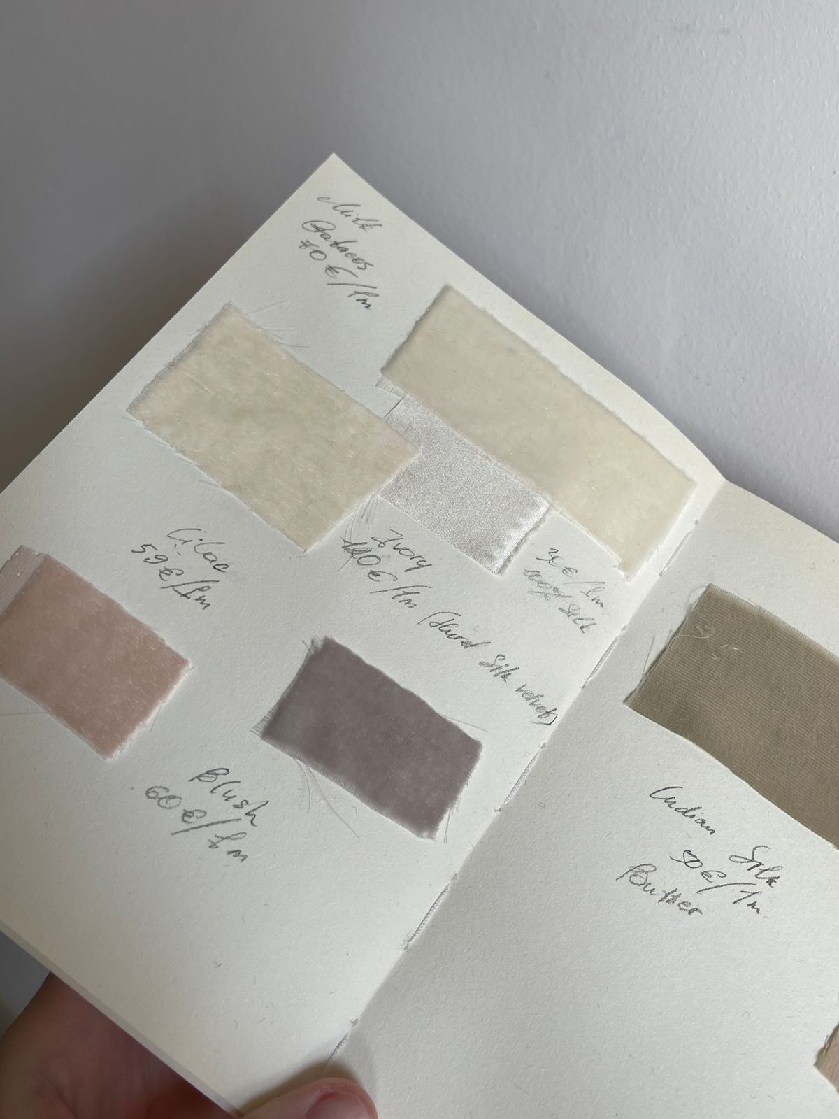A hand-picked sample book of upholstery and curtain fabrics